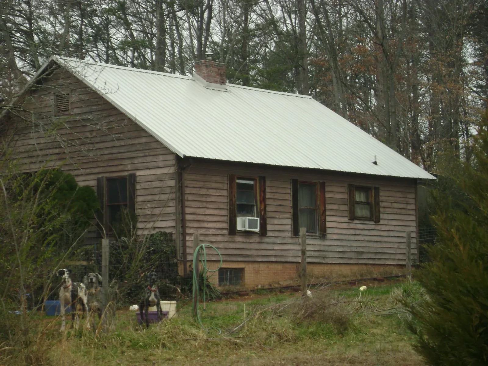 White metal roof on an old wood sided farmhouse, from a Metal Roof Installation job in Bunnlevel